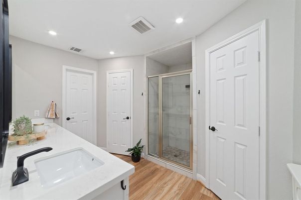 Bathroom, Dual Sink Vanities, Glass Shower, Interior, Recessed Lighting, Wood Texture Flooring