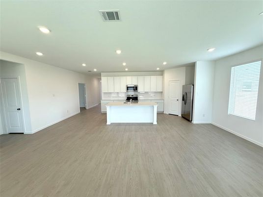 Empty room, Interior, Kitchen, Recessed Lighting, Stainless Steel Appliances, Wood Texture Flooring