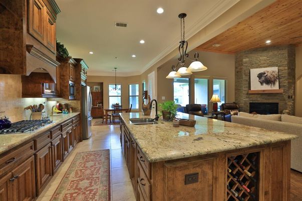 Chandelier, Dining room, Fireplace, Interior, Kitchen, Living room, Pendant Lights, Recessed Lighting, Stone Walls, Wooden Ceilings