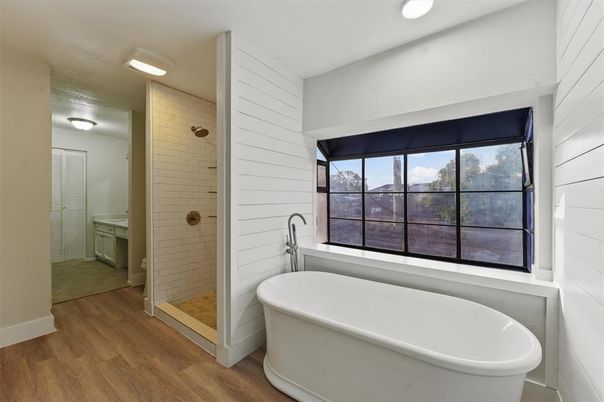 Bathroom, Free Standing Baths, Glass Shower, Interior, Recessed Lighting, Wood Texture Flooring