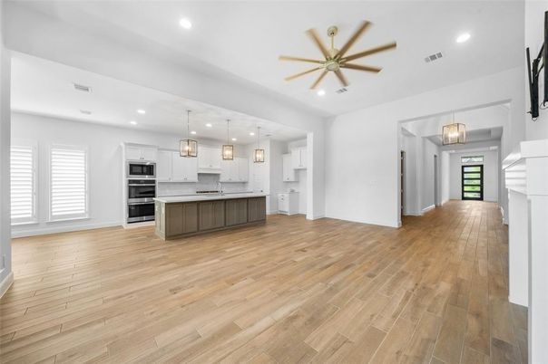 Empty room, Interior, Kitchen, Pendant Lights, Recessed Lighting, Stainless Steel Appliances, Wood Texture Flooring