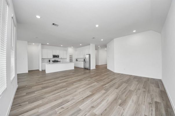 Empty room, Interior, Kitchen, Recessed Lighting, Stainless Steel Appliances, Wood Texture Flooring