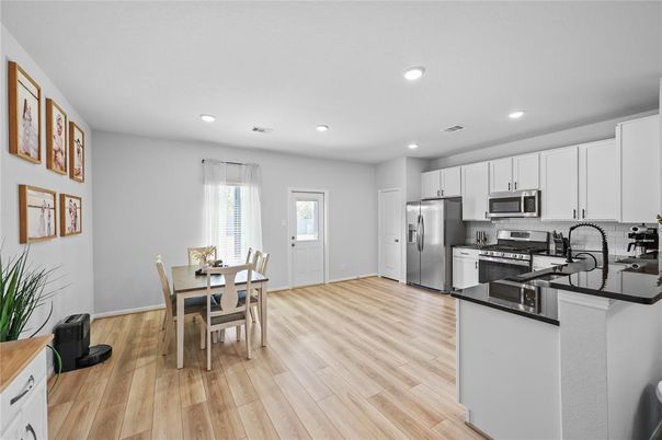 Dining room, Interior, Kitchen, Recessed Lighting, Stainless Steel Appliances, Wood Texture Flooring