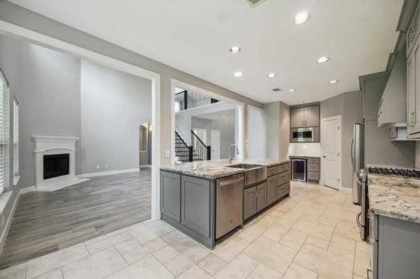 Fireplace, Interior, Kitchen, Recessed Lighting, Stainless Steel Appliances, Wood Texture Flooring