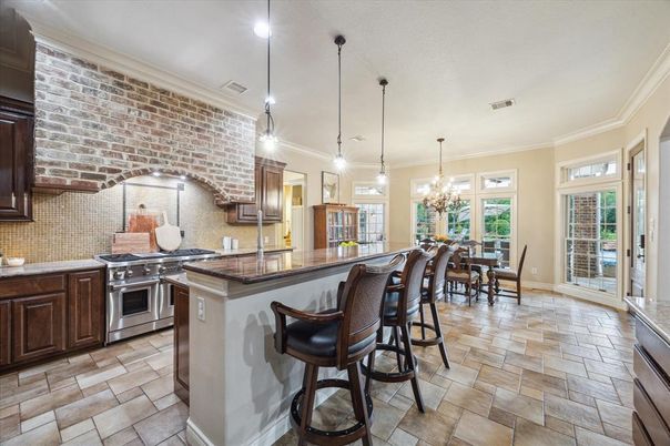 Chandelier, Dining room, Interior, Kitchen, Pendant Lights, Recessed Lighting, Stainless Steel Appliances, Stone Walls