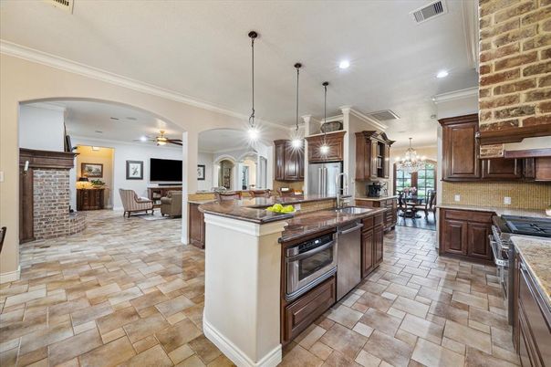 Chandelier, Dining room, Fireplace, Interior, Kitchen, Pendant Lights, Recessed Lighting, Stainless Steel Appliances, Stone Walls