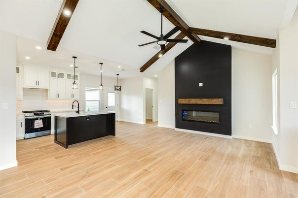 Empty room, Fireplace, Interior, Kitchen, Pendant Lights, Recessed Lighting, Stainless Steel Appliances, Wooden Beams, Wood Texture Flooring