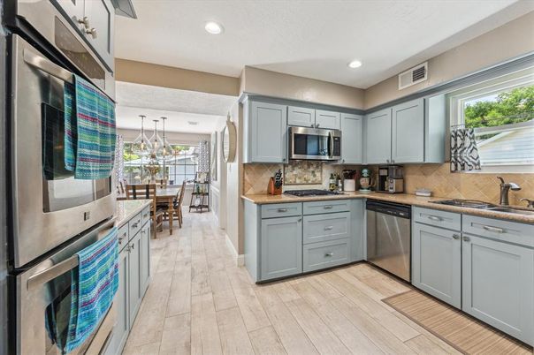 Dining room, Interior, Kitchen, Pendant Lights, Recessed Lighting, Stainless Steel Appliances, Wood Texture Flooring