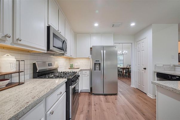 Chandelier, Dining room, Interior, Kitchen, Pendant Lights, Recessed Lighting, Stainless Steel Appliances, Wood Texture Flooring