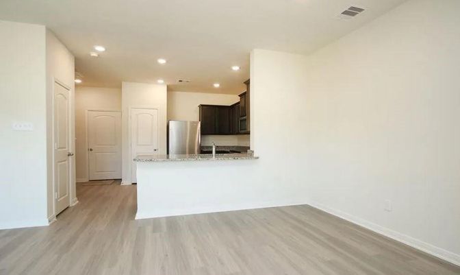 Empty room, Interior, Kitchen, Recessed Lighting, Stainless Steel Appliances, Wood Texture Flooring