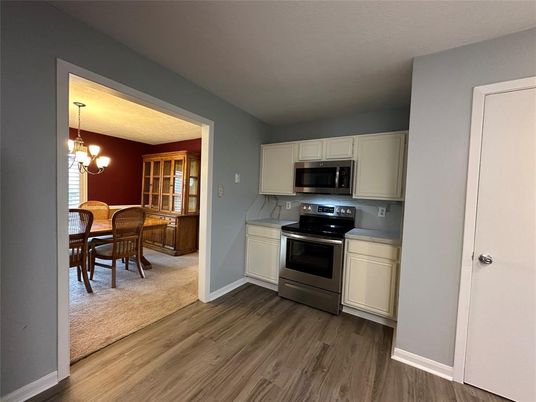 Chandelier, Dining room, Interior, Kitchen, Pendant Lights, Stainless Steel Appliances, Wood Texture Flooring