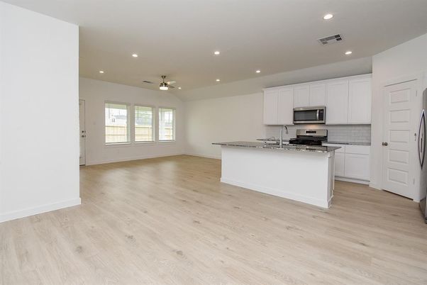 Empty room, Interior, Kitchen, Recessed Lighting, Stainless Steel Appliances, Wood Texture Flooring