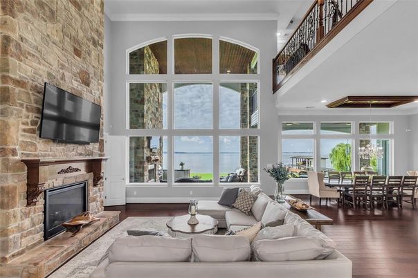 Dining room, Fireplace, Interior, Living room, Recessed Lighting, Stone Walls, Water, Wood Texture Flooring
