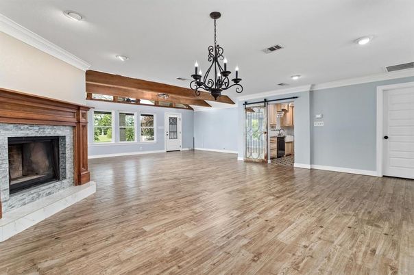 Chandelier, Empty room, Fireplace, Interior, Recessed Lighting, Wooden Beams, Wood Texture Flooring