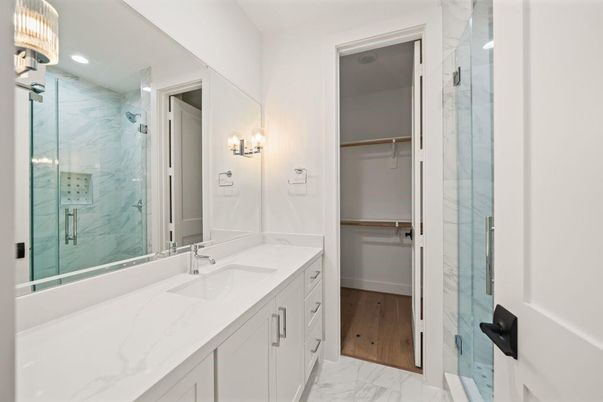 Bathroom, Dual Sink Vanities, Glass Shower, Interior, Marble, Marble Walls, Recessed Lighting, Wood Texture Flooring