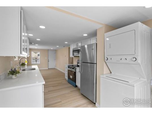 Interior, Kitchen, Recessed Lighting, Washer, Wood Texture Flooring