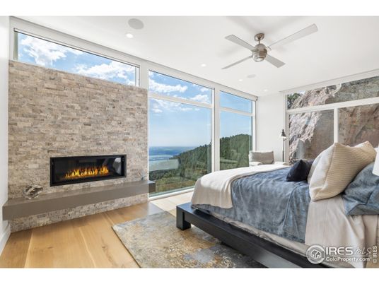 Bedroom, Fireplace, Interior, Recessed Lighting, Stone Walls, Water, Wood Texture Flooring
