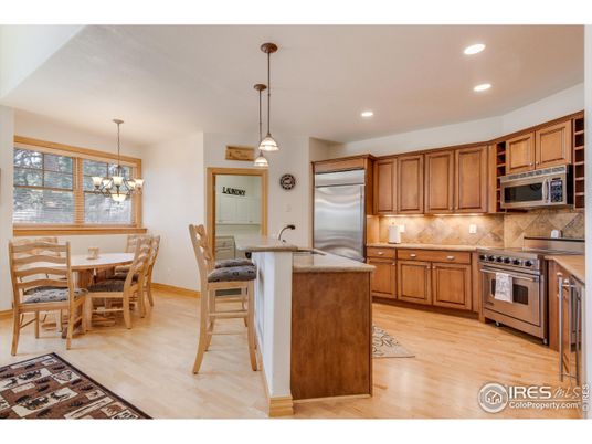 Chandelier, Dining room, Interior, Kitchen, Pendant Lights, Recessed Lighting, Stainless Steel Appliances, Wood Texture Flooring
