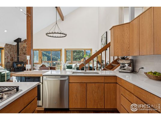 Fireplace, Interior, Kitchen, Pendant Lights, Stainless Steel Appliances, Stone Walls, Wooden Beams
