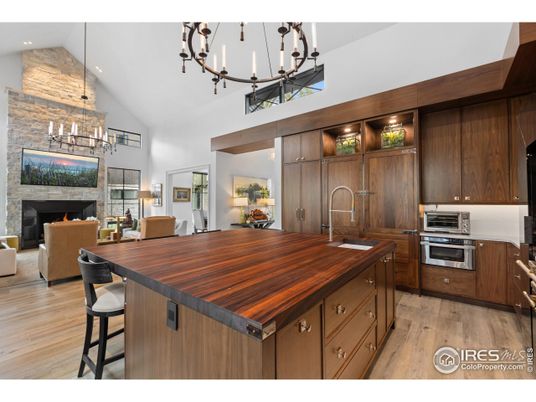 Chandelier, Fireplace, Interior, Kitchen, Living room, Recessed Lighting, Stainless Steel Appliances, Wood Texture Flooring