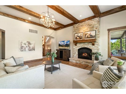Chandelier, Fireplace, Interior, Living room, Recessed Lighting, Stone Walls, Wooden Beams, Wood Texture Flooring