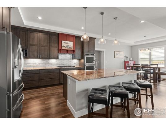 Chandelier, Dining room, Interior, Kitchen, Pendant Lights, Recessed Lighting, Stainless Steel Appliances, Wood Texture Flooring