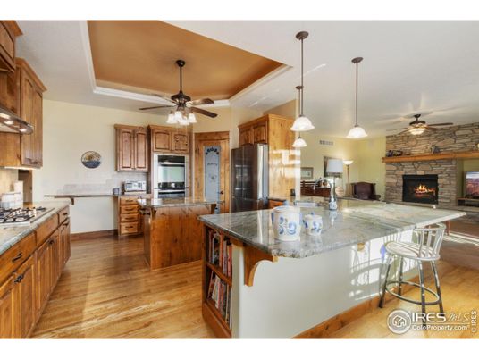 Fireplace, Interior, Kitchen, Pendant Lights, Recessed Lighting, Stainless Steel Appliances, Stone Walls, Wood Texture Flooring