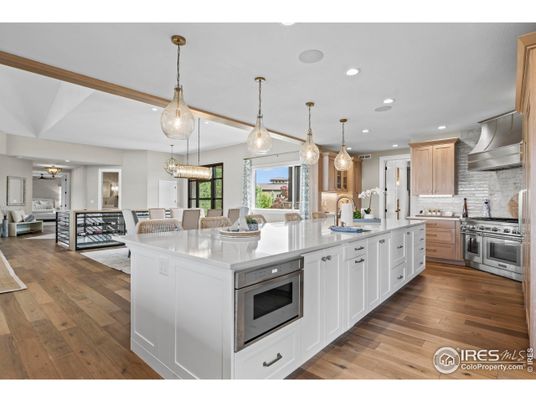 Chandelier, Dining room, Interior, Kitchen, Living room, Pendant Lights, Recessed Lighting, Stainless Steel Appliances, Wood Texture Flooring