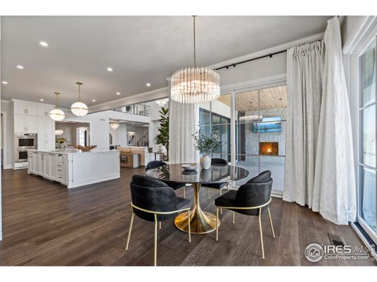 Chandelier, Dining room, Fireplace, Interior, Kitchen, Living room, Pendant Lights, Recessed Lighting, Stainless Steel Appliances, Wood Texture Flooring