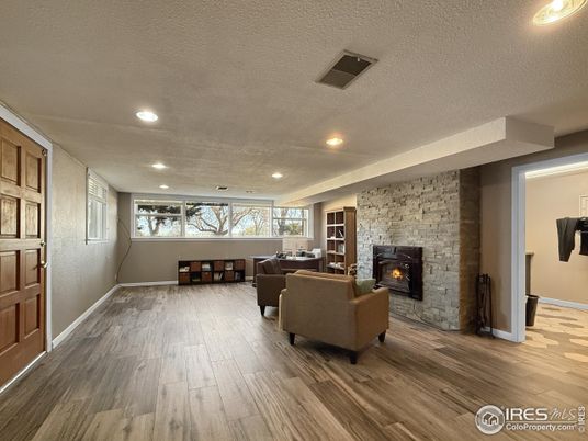 Fireplace, Interior, Living room, Recessed Lighting, Stone Walls, Wood Texture Flooring