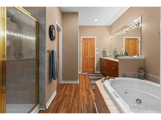Bathroom, Dual Sink Vanities, Glass Shower, Interior, Recessed Lighting, Tile Countertops, Wood Texture Flooring
