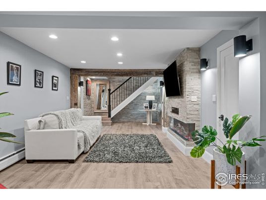 Fireplace, Interior, Living room, Recessed Lighting, Stone Walls, Wood Texture Flooring