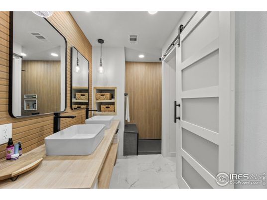 Bathroom, Dual Sink Vanities, Free Standing Baths, Interior, Marble, Pendant Lights, Recessed Lighting, Wooden Walls