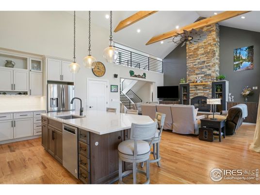 Fireplace, Interior, Kitchen, Living room, Pendant Lights, Recessed Lighting, Stainless Steel Appliances, Stone Walls, Wooden Beams, Wood Texture Flooring