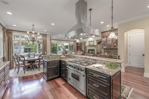 Chandelier, Dining room, Fireplace, Interior, Kitchen, Pendant Lights, Recessed Lighting, Stainless Steel Appliances, Wood Texture Flooring