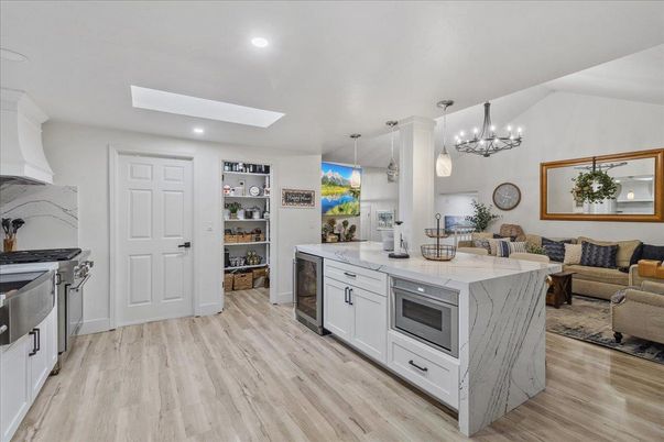 Chandelier, Dining room, Interior, Kitchen, Living room, Pendant Lights, Recessed Lighting, Stainless Steel Appliances, Wood Texture Flooring