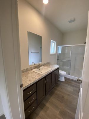 Bathroom, Dual Sink Vanities, Glass Shower, Interior, Recessed Lighting, Wood Texture Flooring