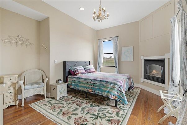 Bedroom, Chandelier, Fireplace, Interior, Recessed Lighting, Wood Texture Flooring