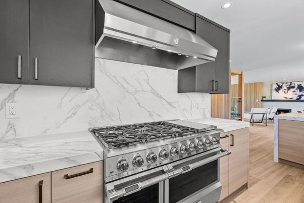 Interior, Kitchen, Marble Walls, Recessed Lighting, Stainless Steel Appliances, Wood Texture Flooring