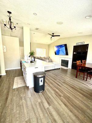 Chandelier, Dining room, Fireplace, Interior, Living room, Recessed Lighting, Wood Texture Flooring