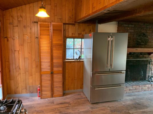Fireplace, Interior, Kitchen, Stainless Steel Appliances, Stone Walls, Wood Texture Flooring, Wooden Walls