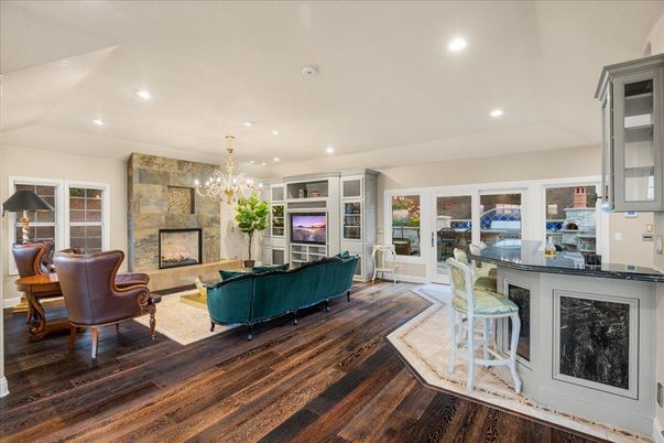 Chandelier, Fireplace, Interior, Living room, Recessed Lighting, Stone Walls, Wood Texture Flooring