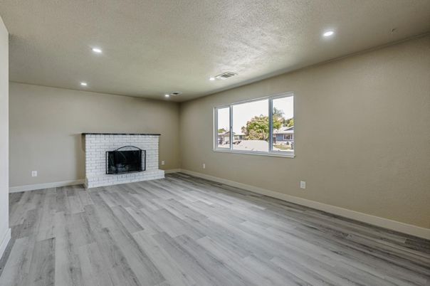 Empty room, Fireplace, Interior, Recessed Lighting, Stone Walls, Wood Texture Flooring