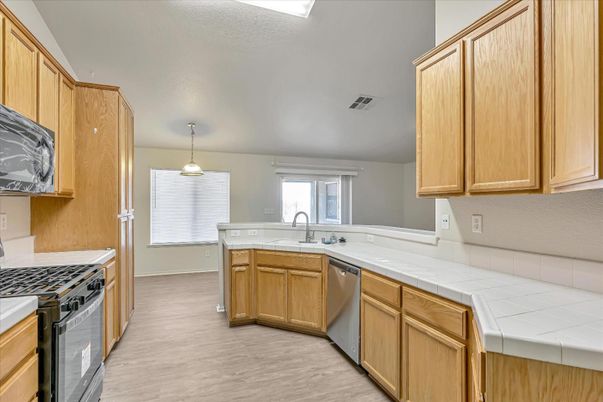 Interior, Kitchen, Pendant Lights, Tile Countertops, Wood Texture Flooring