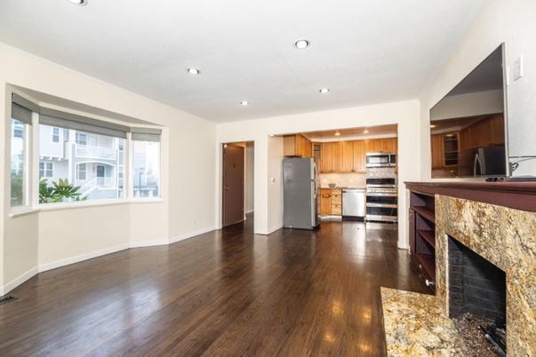 Fireplace, Interior, Kitchen, Recessed Lighting, Stainless Steel Appliances, Wood Texture Flooring
