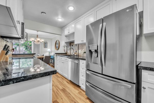 Chandelier, Dining room, Interior, Kitchen, Recessed Lighting, Stainless Steel Appliances, Wood Texture Flooring