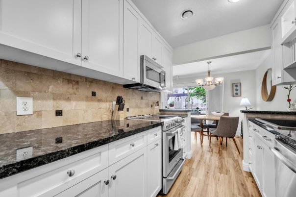 Chandelier, Dining room, Interior, Kitchen, Recessed Lighting, Stainless Steel Appliances, Wood Texture Flooring