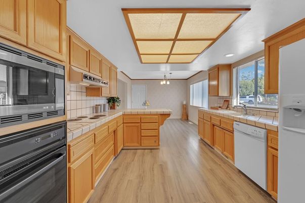 Interior, Kitchen, Pendant Lights, Tile Countertops, Wood Texture Flooring