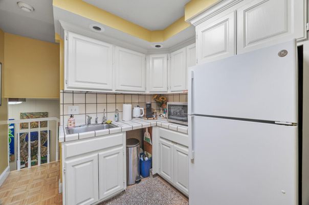 Interior, Kitchen, Recessed Lighting, Tile Countertops, Wood Texture Flooring