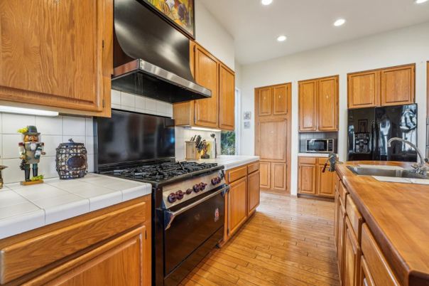 Interior, Kitchen, Recessed Lighting, Tile Countertops, Wood Texture Flooring